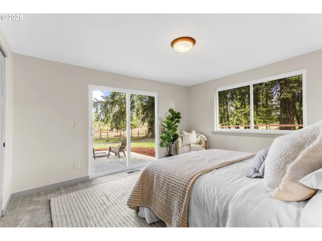 a bedroom with a bed and a large window