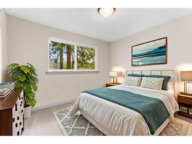 a bedroom with a bed and a painting on the wall