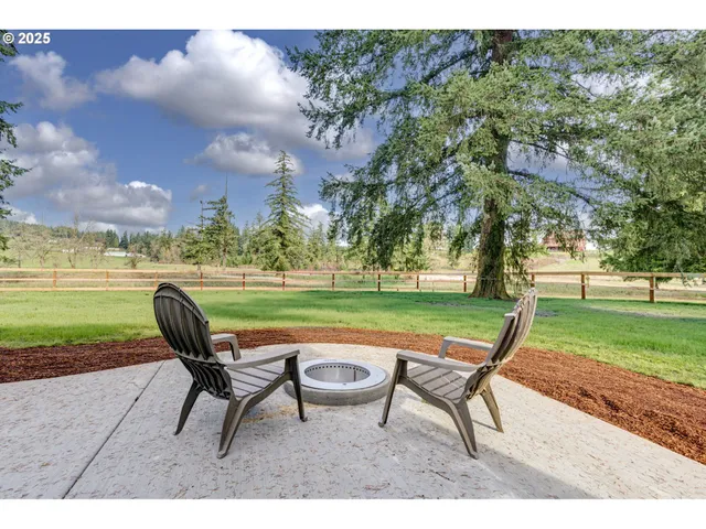 a park bench sitting in a park with large trees