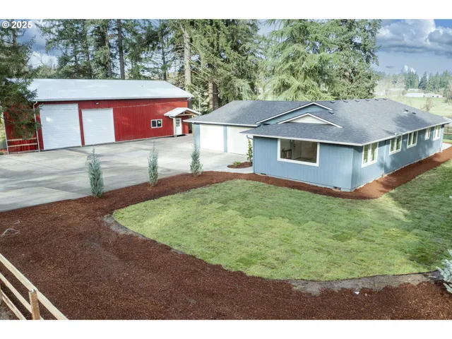 a aerial view of a house next to a big yard