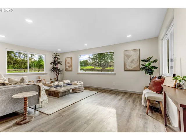 a living room with furniture and a potted plant