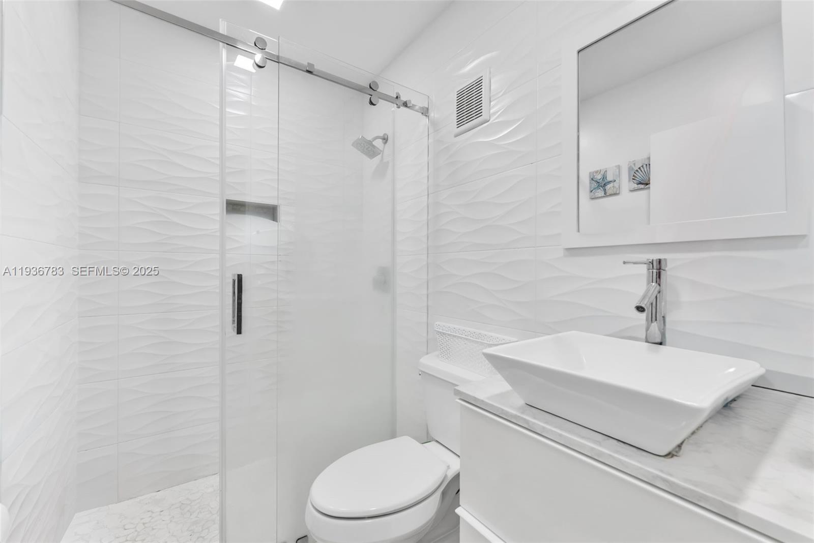 3725 Southwest 153rd Court Miami, FL 33185 - Photo 16 of 22 a bathroom with a sink a toilet and shower