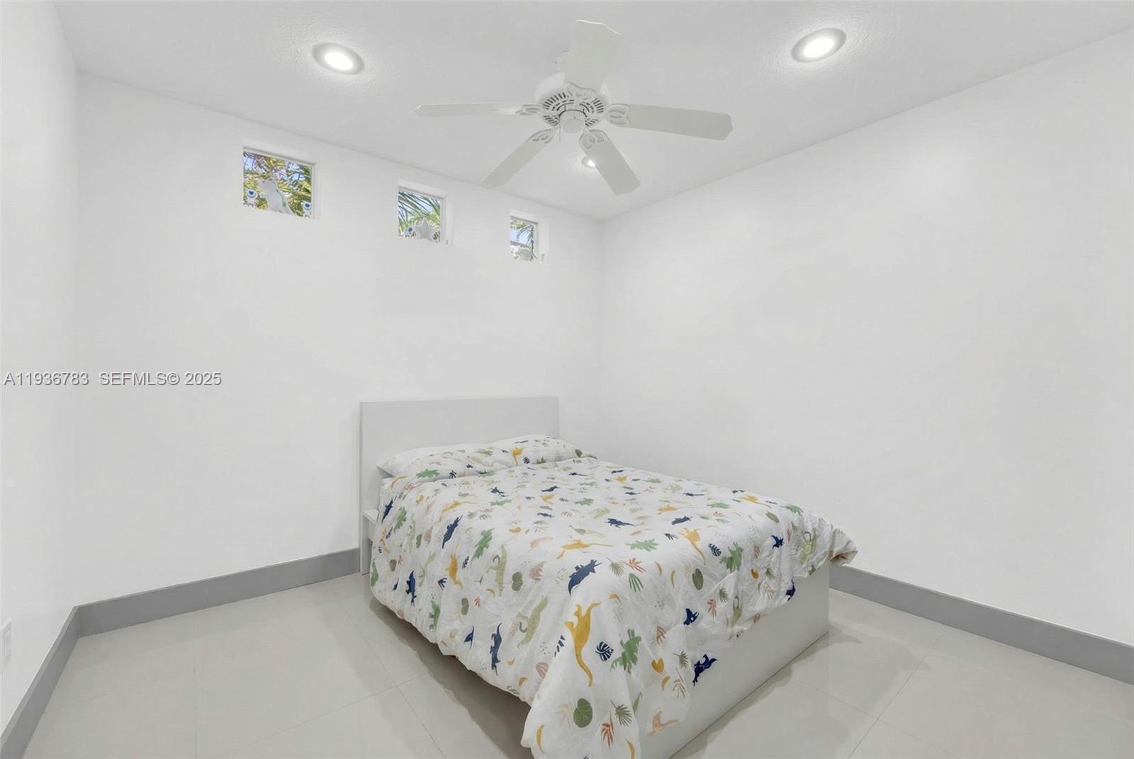 3725 Southwest 153rd Court Miami, FL 33185 - Photo 19 of 22 a bedroom with a bed and a chandelier