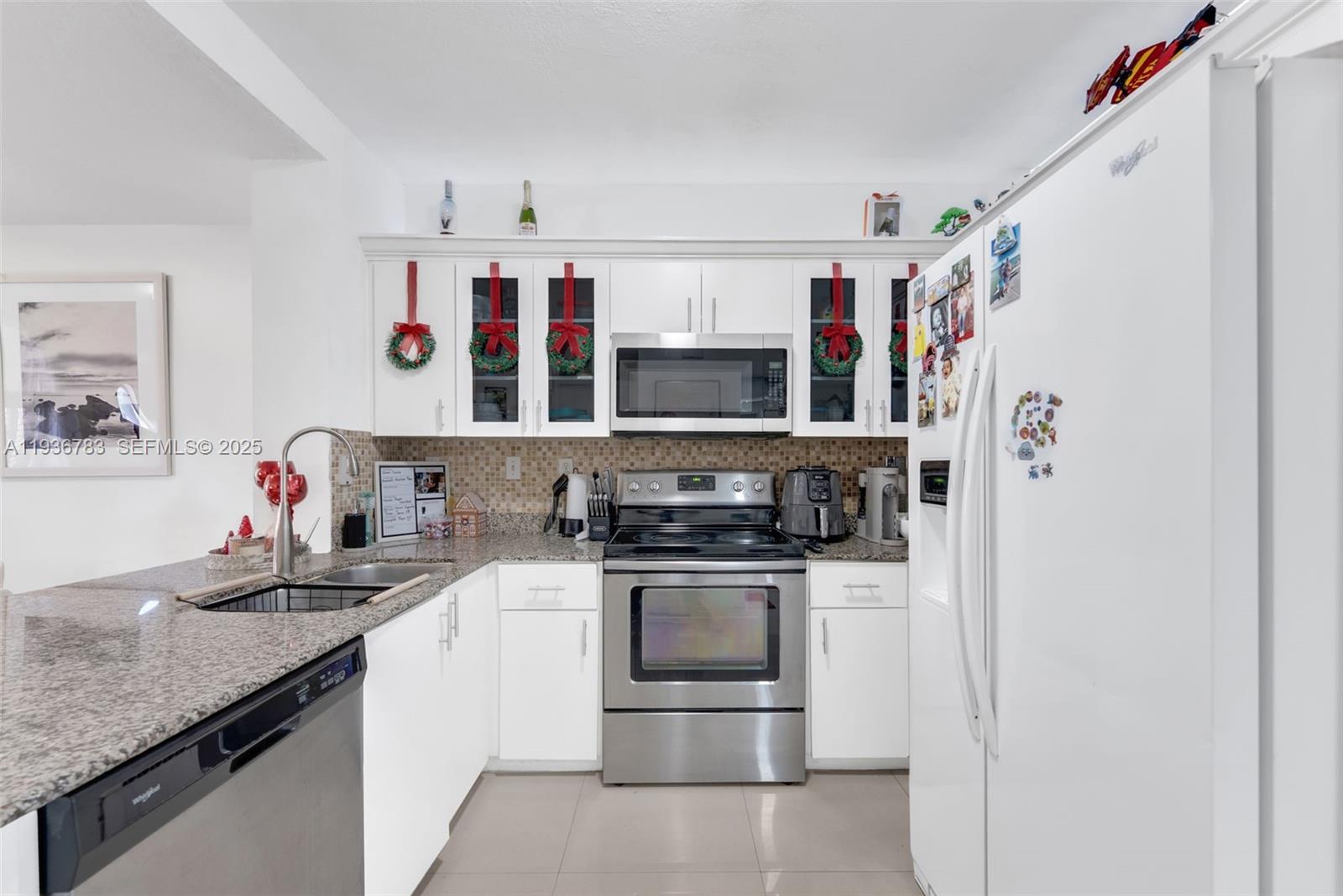 3725 Southwest 153rd Court Miami, FL 33185 - Photo 8 of 22 a kitchen with stainless steel appliances granite countertop a sink and a refrigerator
