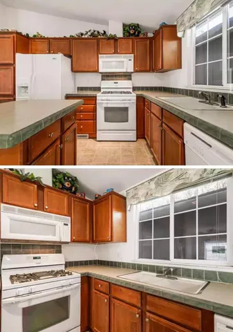 a view of a kitchen with stainless steel appliances granite countertop a stove and a large window