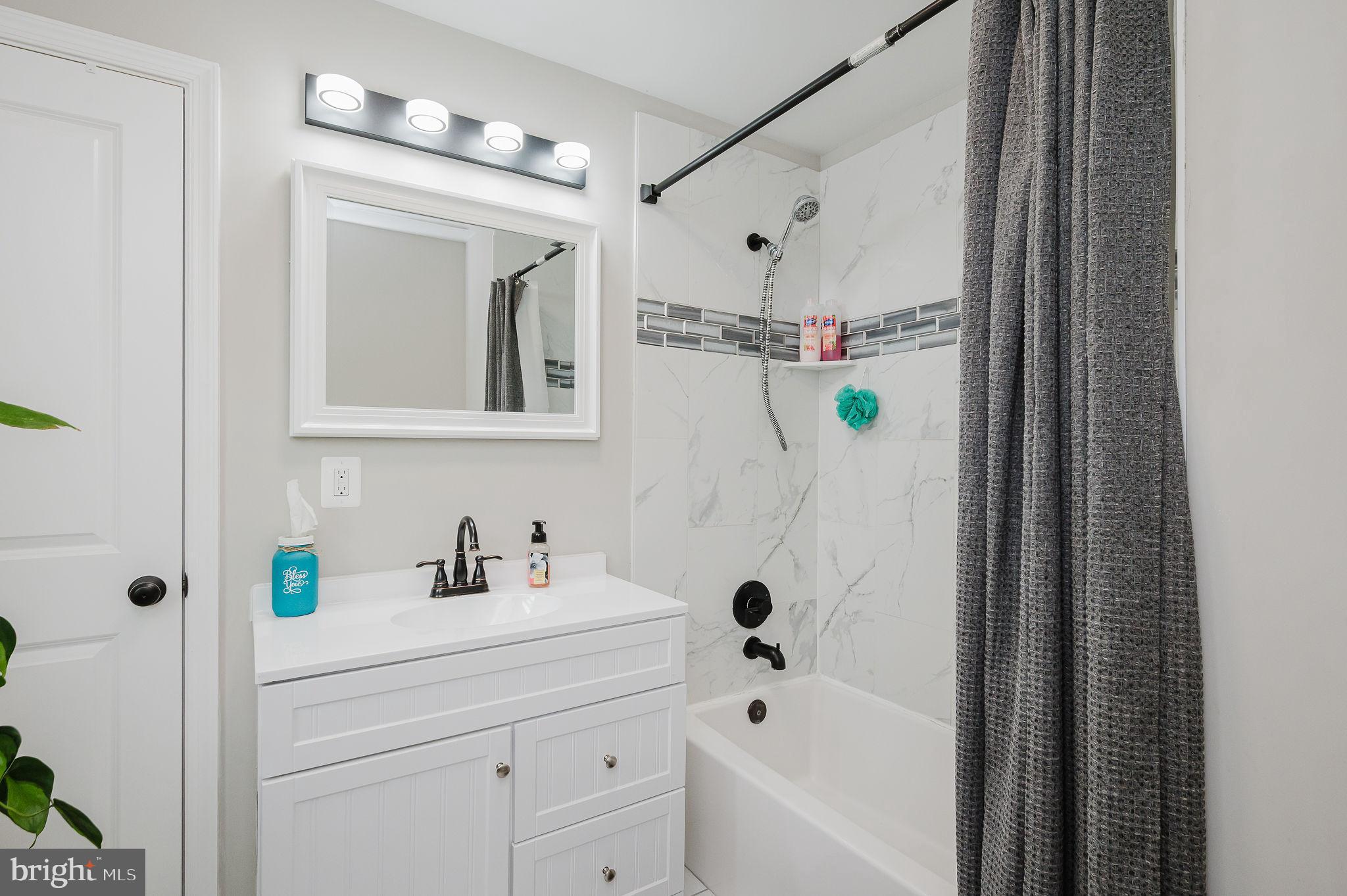 4 Right Aileron Baltimore, MD 21220 - Photo 17 of 30 a bathroom with a bathtub a sink a window and a shower