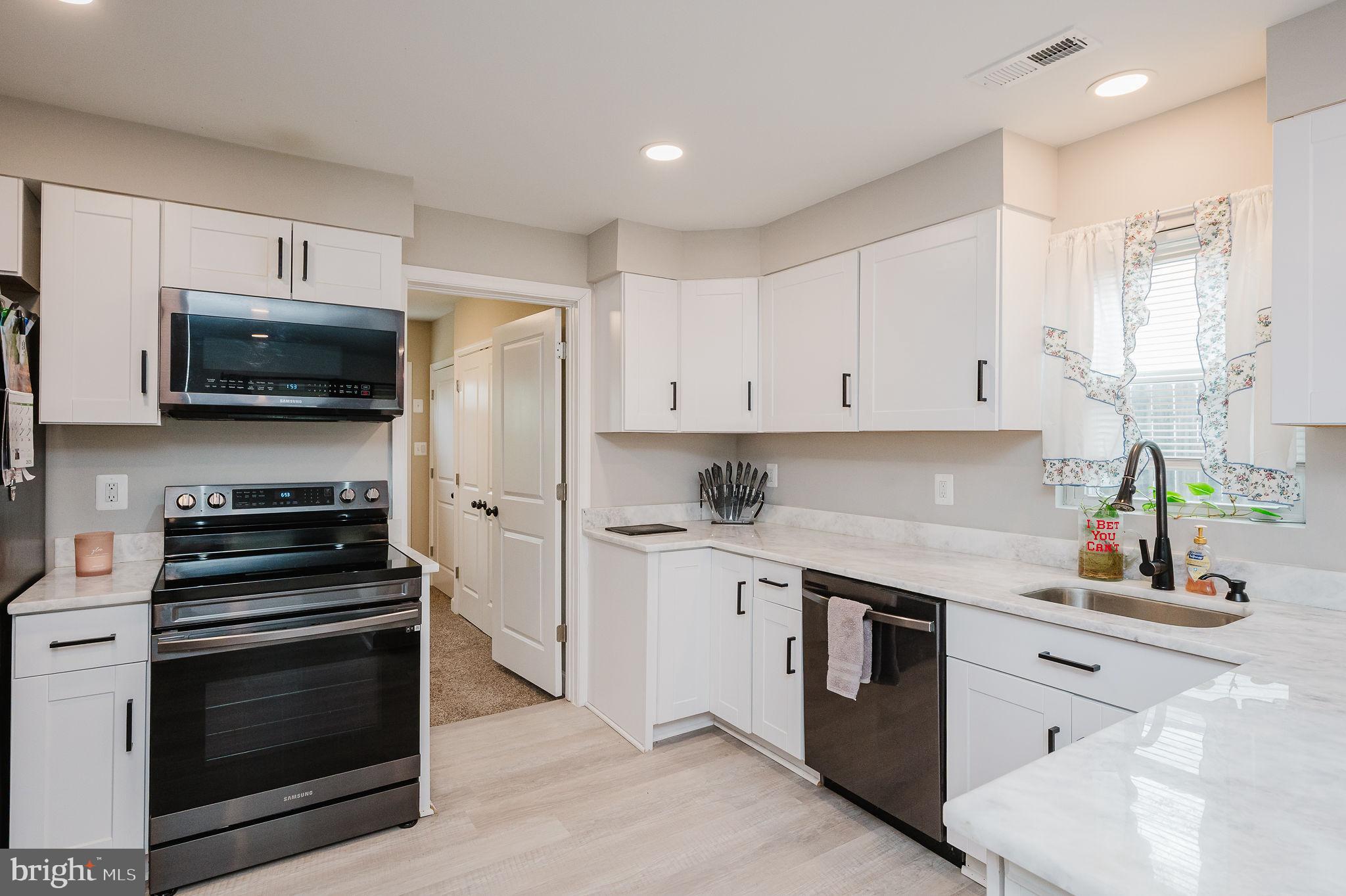 4 Right Aileron Baltimore, MD 21220 - Photo 8 of 30 a kitchen with cabinets stainless steel appliances and a counter space