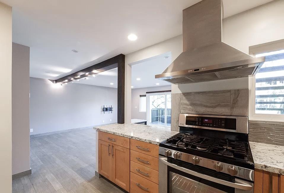 4927 Indian Wood Road Culver City, CA 90230 - Photo 16 of 20 a kitchen with granite countertop a stove and a refrigerator