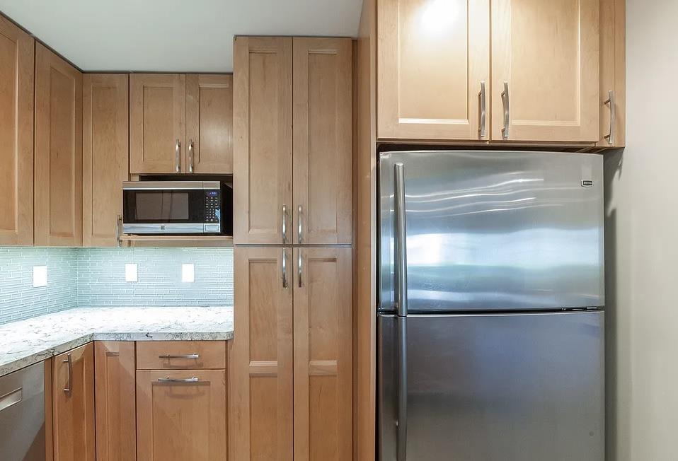 4927 Indian Wood Road Culver City, CA 90230 - Photo 20 of 20 a kitchen with granite countertop cabinets and a refrigerator