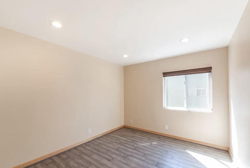 4927 Indian Wood Road Culver City, CA 90230 - Photo 8 of 20 an empty room with wooden floor and windows