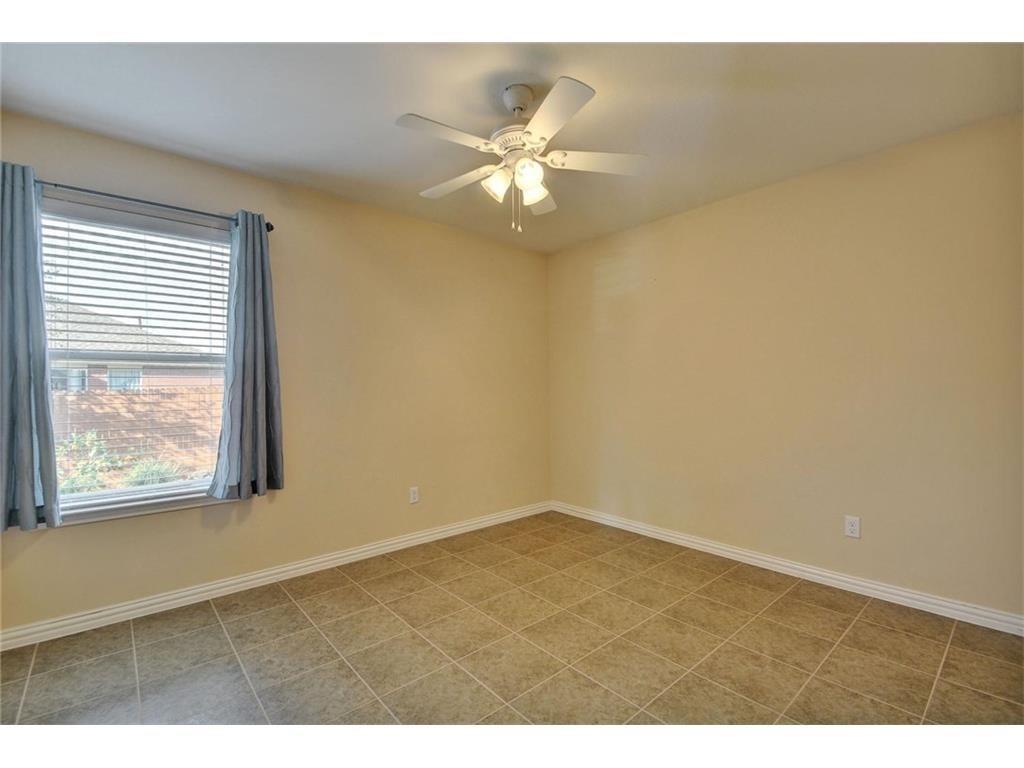 2109 Granite Springs Road Leander, TX 78641 - Photo 14 of 30 A comfortable bedroom with tile flooring and a ceiling fan awaits personalization.