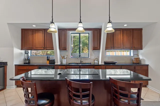 a kitchen with stainless steel appliances granite countertop a refrigerator and a stove