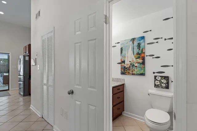 a bathroom with a granite countertop sink mirror vanity and toilet