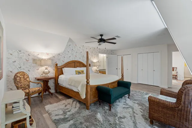 a spacious bedroom with a bed and a chandelier