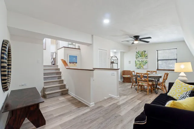a view of a dining room with furniture and a chandelier