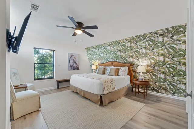 a bedroom with a bed and a flat screen tv