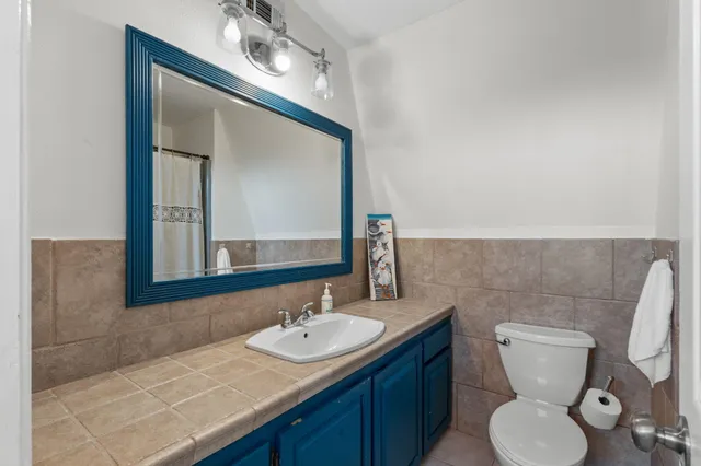 a bathroom with a shower and a mirror