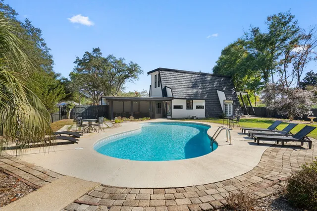 a view of a backyard with large tree