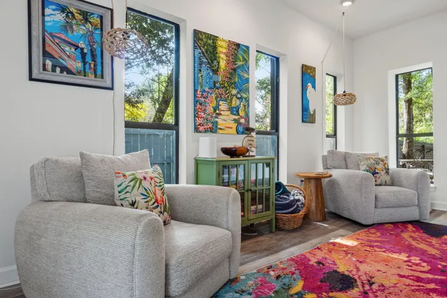 a living room with furniture and a floor to ceiling window