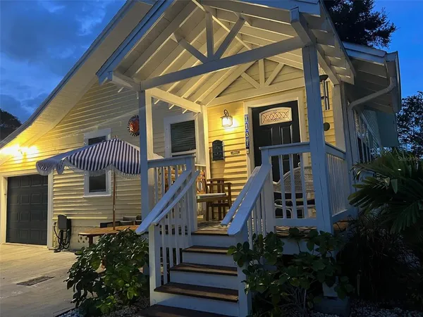 a front view of a house with outdoor seating