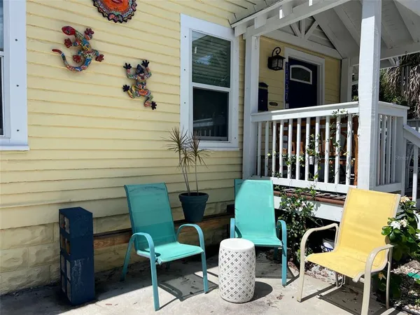 a view of a chairs and table in backyard