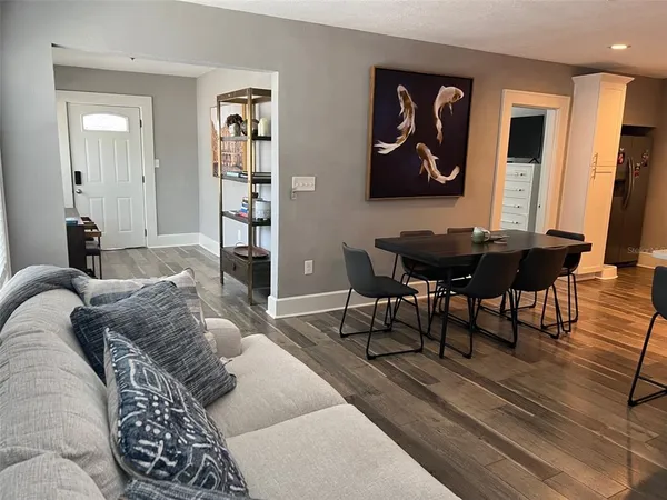 a bedroom with a bed and wall painting on the wall