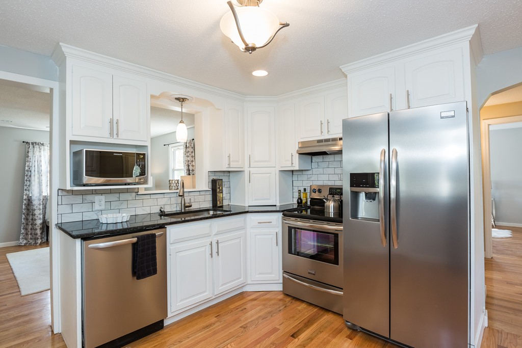 a kitchen with cabinets and stainless steel appliances