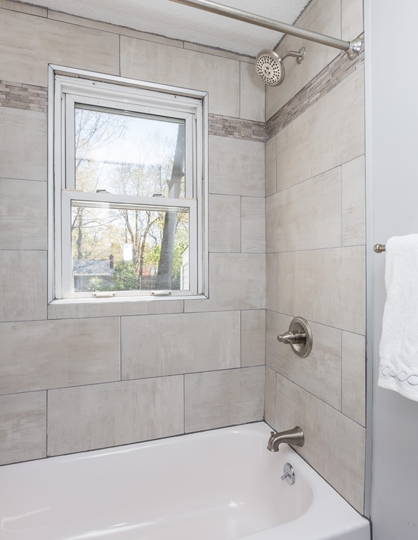 219 Cooper Street Springfield, MA 01108 - Photo 15 of 29 a bathroom with a tub a window and shower