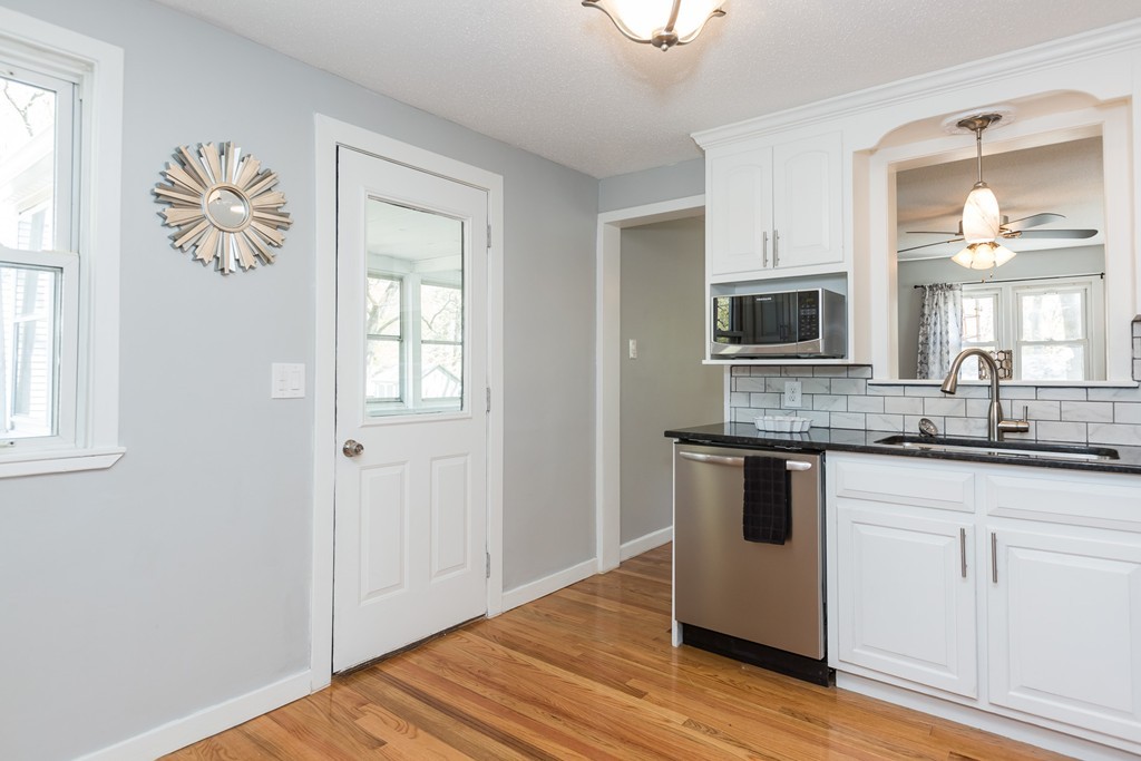 219 Cooper Street Springfield, MA 01108 - Photo 3 of 29 a kitchen with stainless steel appliances granite countertop a stove a sink and a microwave