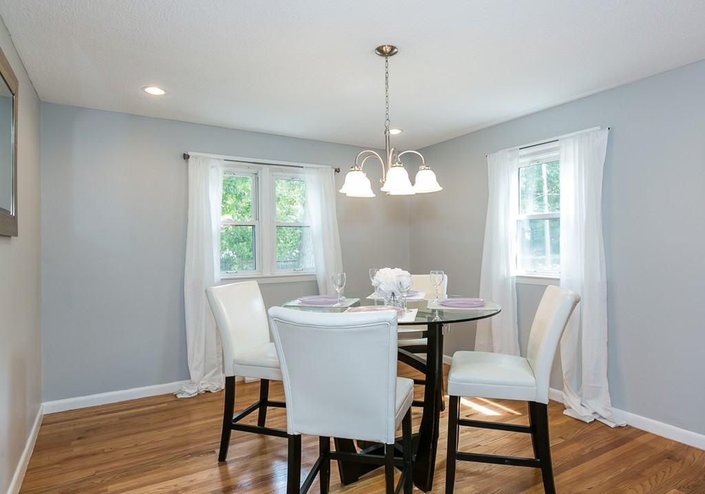 219 Cooper Street Springfield, MA 01108 - Photo 5 of 29 a dining room with furniture a chandelier and wooden floor