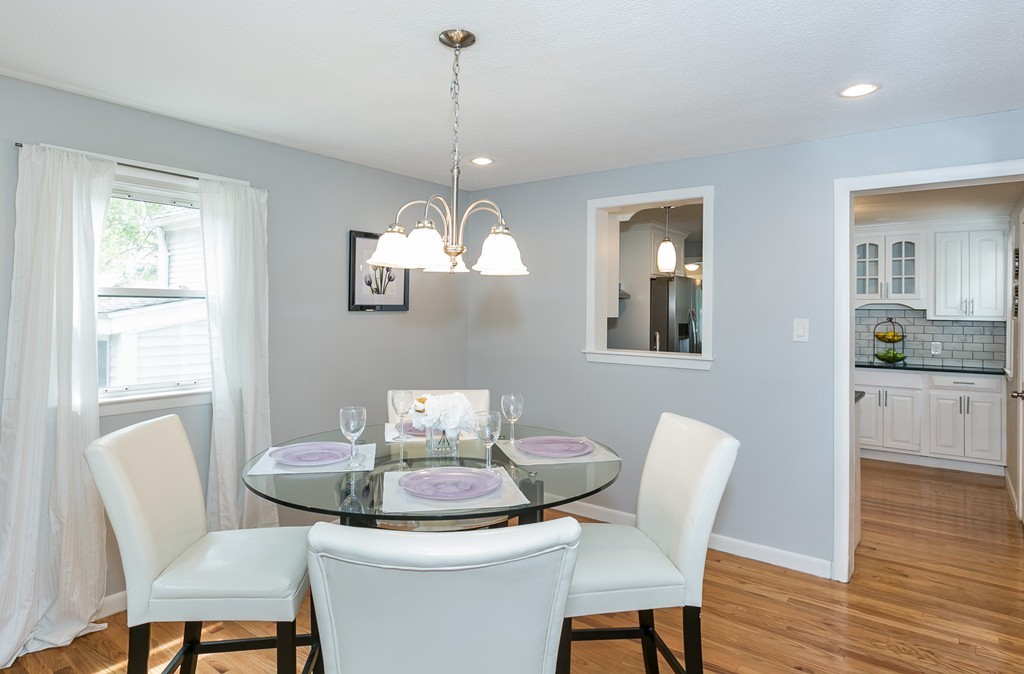 219 Cooper Street Springfield, MA 01108 - Photo 6 of 29 a view of a dining room with furniture wooden floor and a chandelier