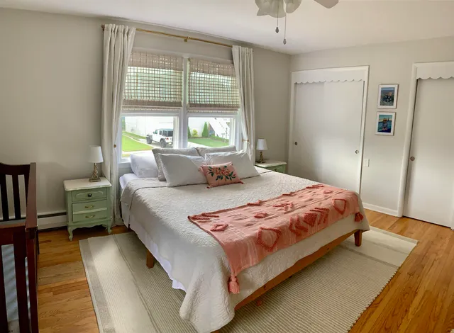 a bedroom with a bed dresser and a window