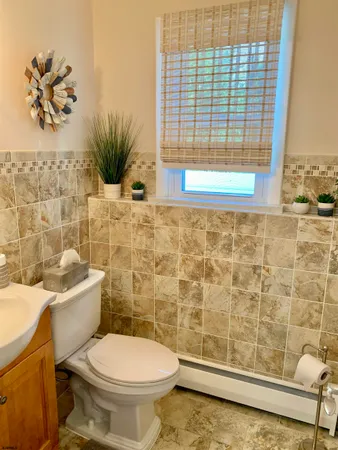 a bathroom with a toilet a sink and a shower