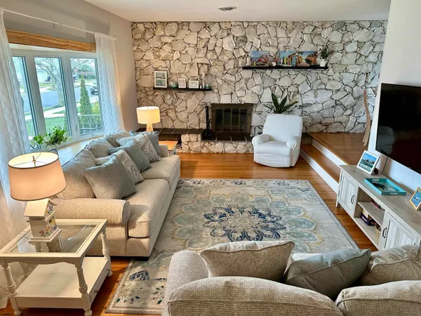 a living room with furniture and a fireplace