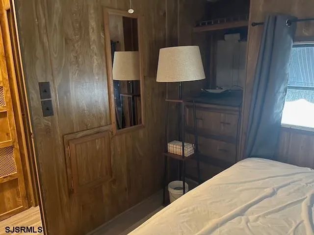 a bedroom with a bed and a lamp on table