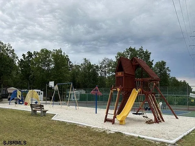 a table and chairs sitting next to a lake