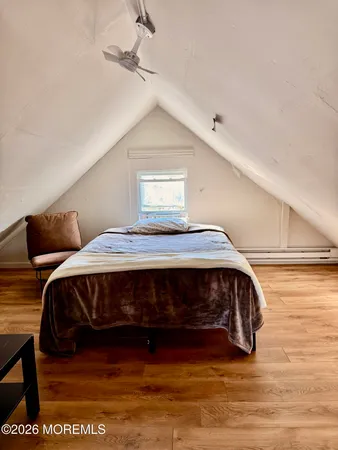a bedroom with a bed and a night stand