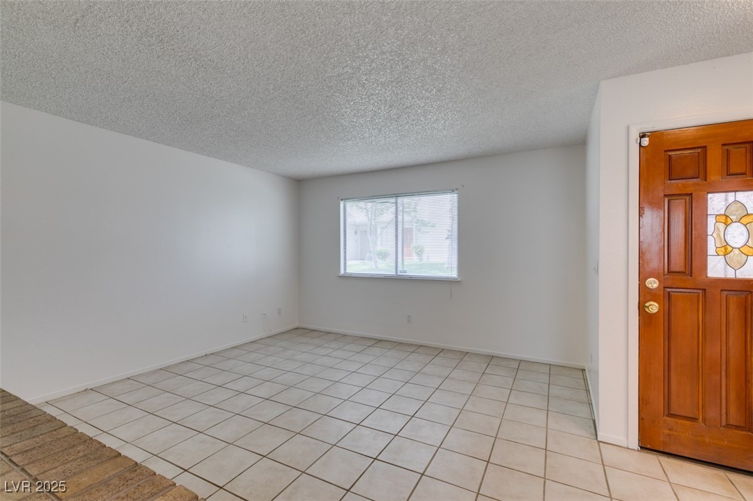 2681 Ruthe Duarte Avenue Las Vegas, NV 89121 - Photo 7 of 43 Entrance foyer with light tile patterned flooring and a textured ceiling