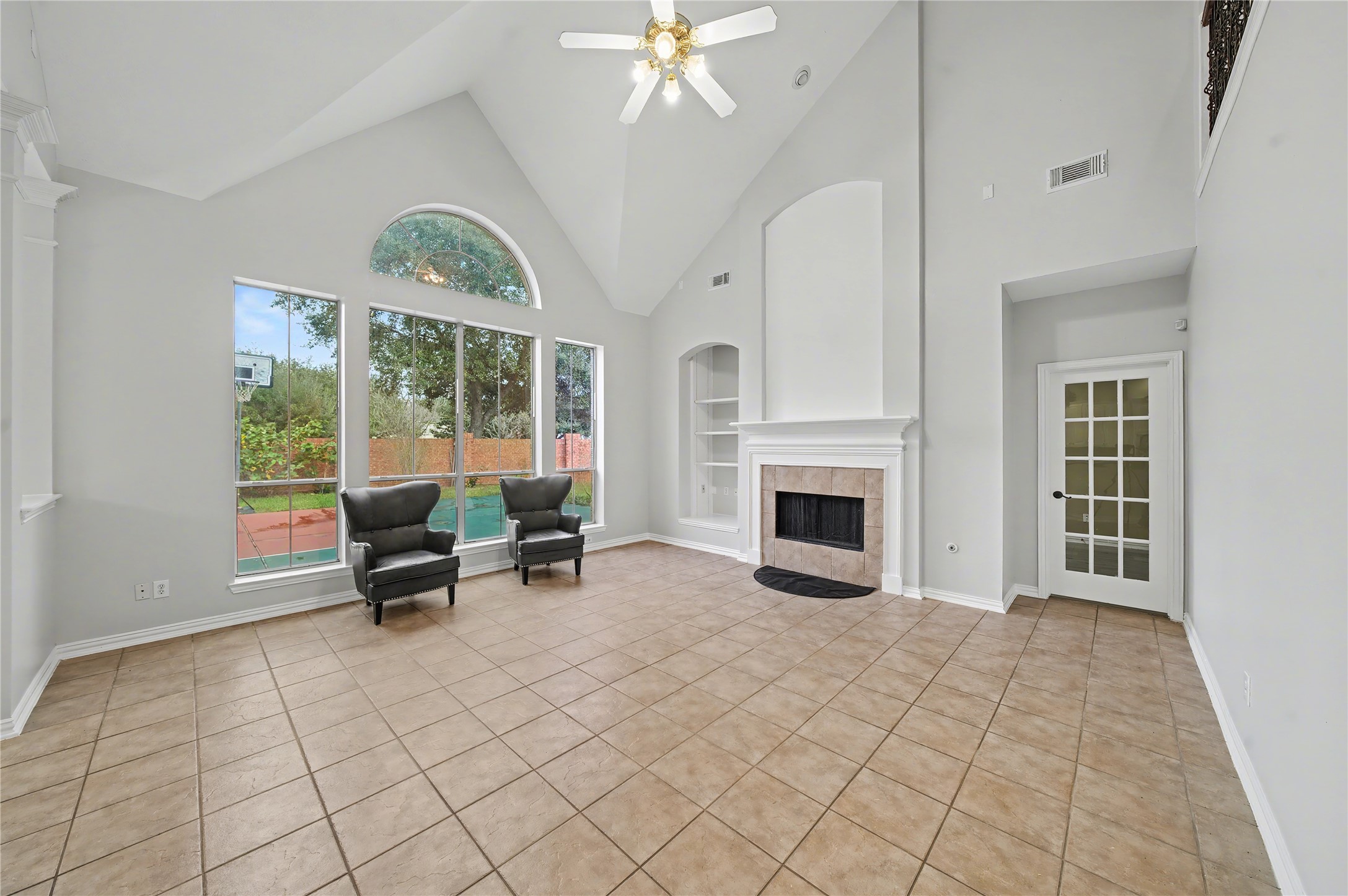 5403 Emerald Pointe Lane Sugar Land, TX 77479 - Photo 23 of 50 an empty room with fireplace fan and windows
