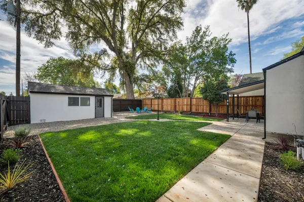 a backyard of a house with table and chairs
