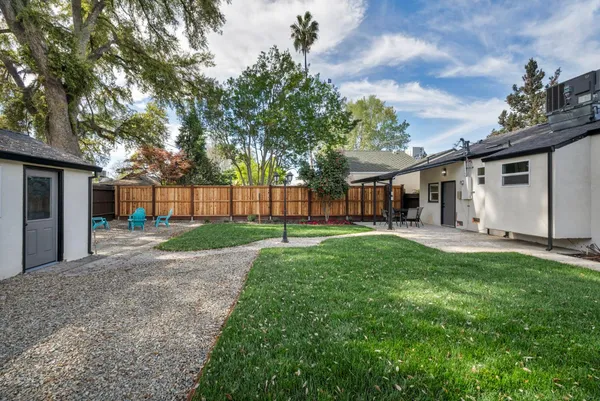 a backyard of a house with table and chairs