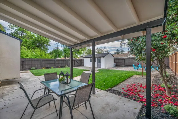 a view of a backyard with a garden and entertaining space