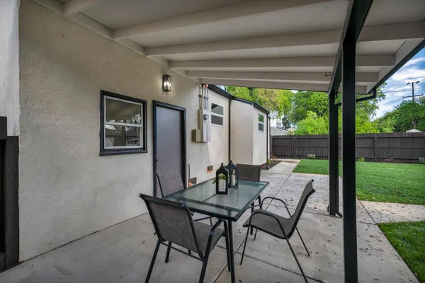 a living room with furniture a flat screen tv and kitchen view