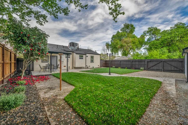 a view of a house with a yard and tree s