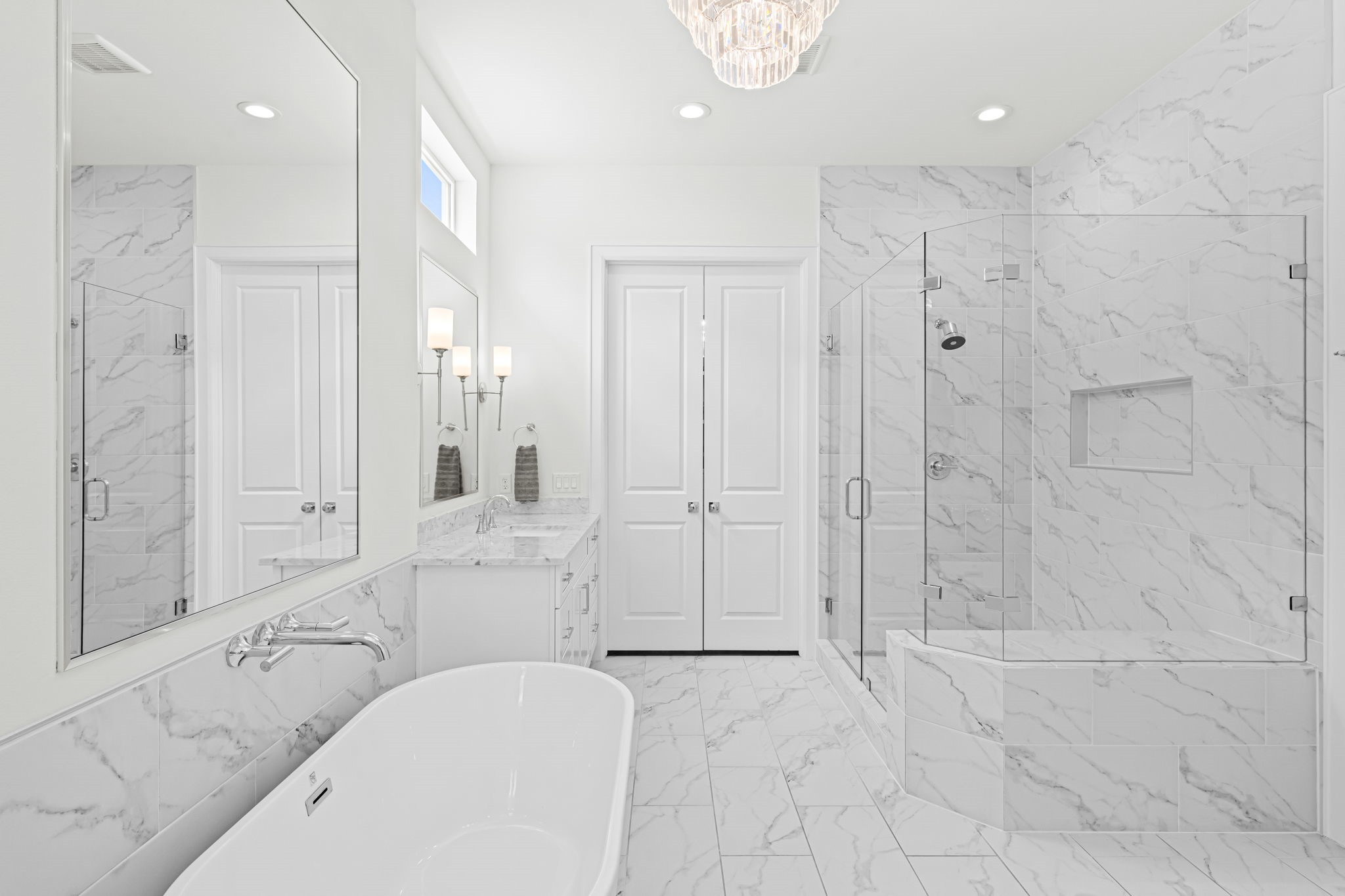 533 West 27th Street Houston, TX 77008 - Photo 14 of 22 Luxurious primary bath blends timeless marble finishes with natural light and generous storage.