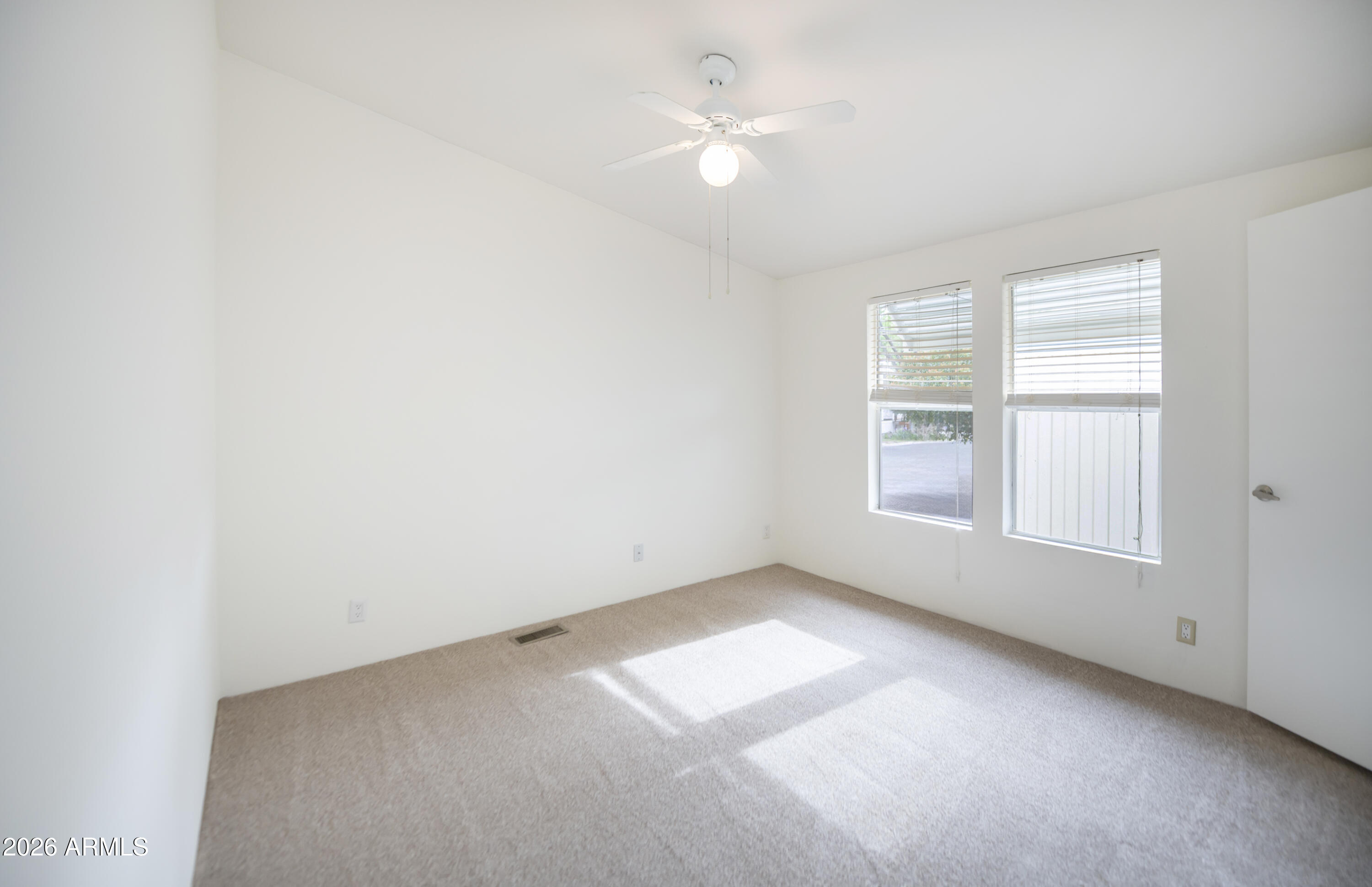 11250 East State Rte 69, Unit 1125 Dewey, AZ 86327 - Photo 30 of 45 an empty room with a window and a ceiling fan