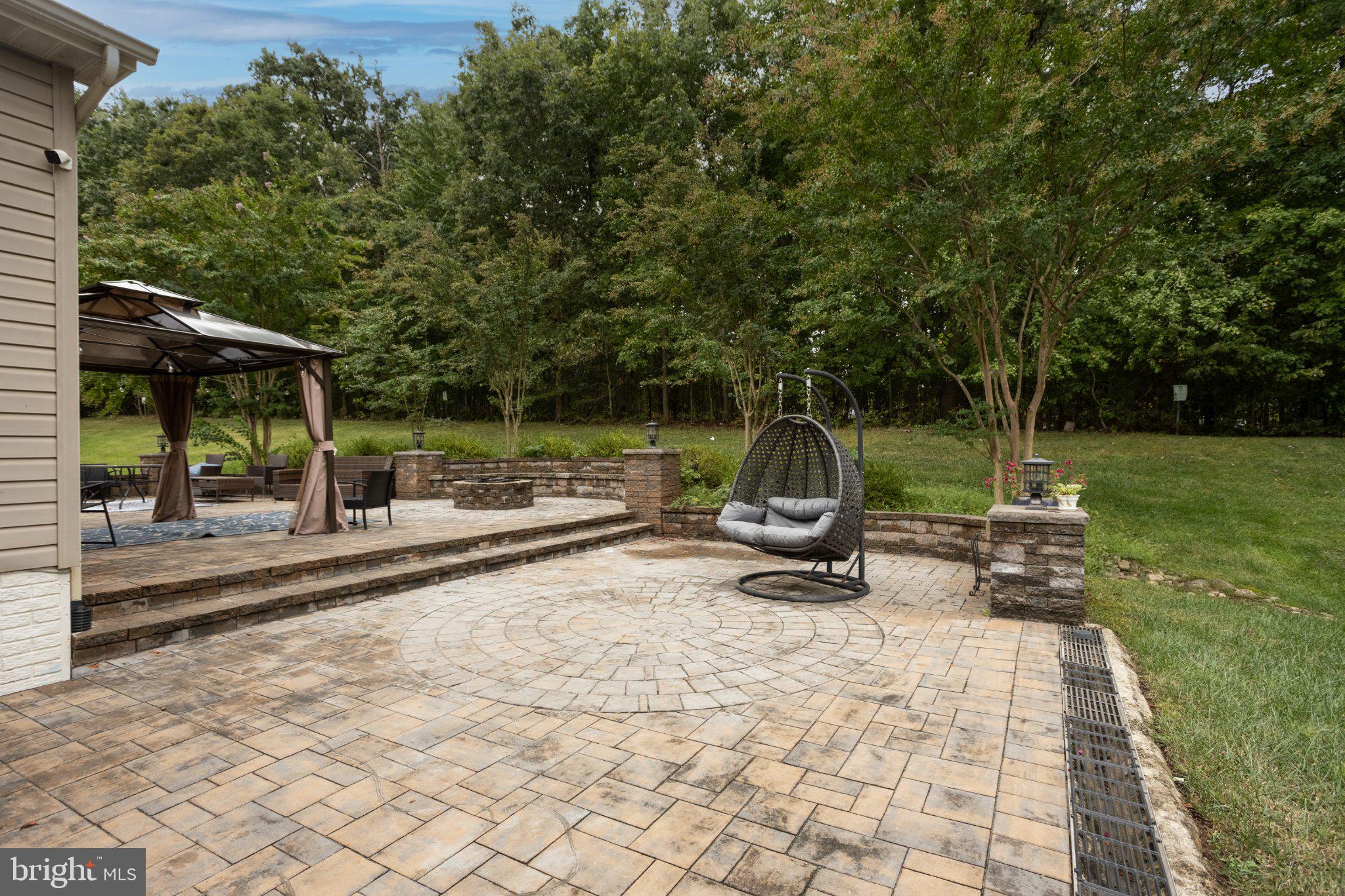7777 Rotherham Drive Hanover, MD 21076 - Photo 59 of 73 Side view of the patio with view to the woods