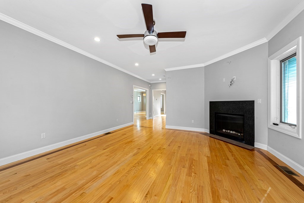 31 Knoll Street Boston, MA 02131 - Photo 16 of 34 a view of empty room with wooden floor and fan