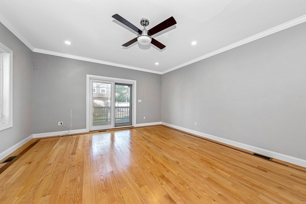 31 Knoll Street Boston, MA 02131 - Photo 17 of 34 an empty room with wooden floor and windows