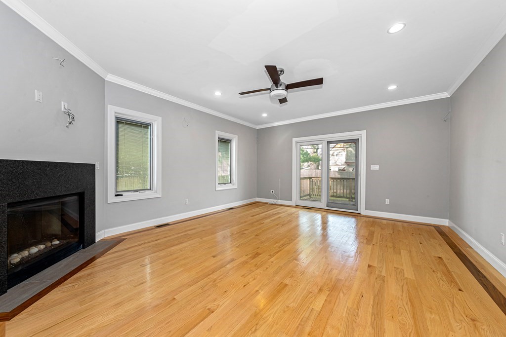 31 Knoll Street Boston, MA 02131 - Photo 18 of 34 a view of empty room with wooden floor and fireplace